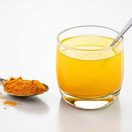a glass of turmeric water