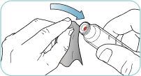 Using a swab to wipe the red inner seal of the pen.