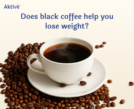 A cup of black coffee with coffee beans surrounding it