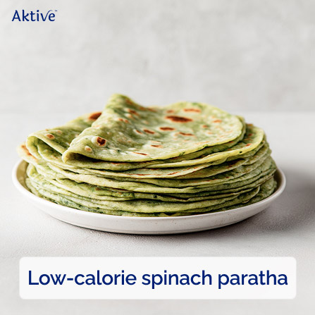 Warm spinach paratha stacked neatly on a plate.