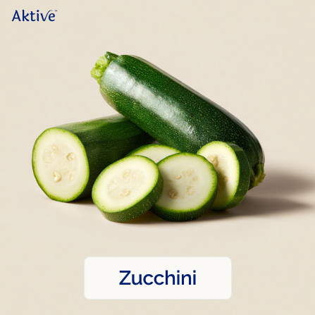 Whole zucchini next to sliced zucchini